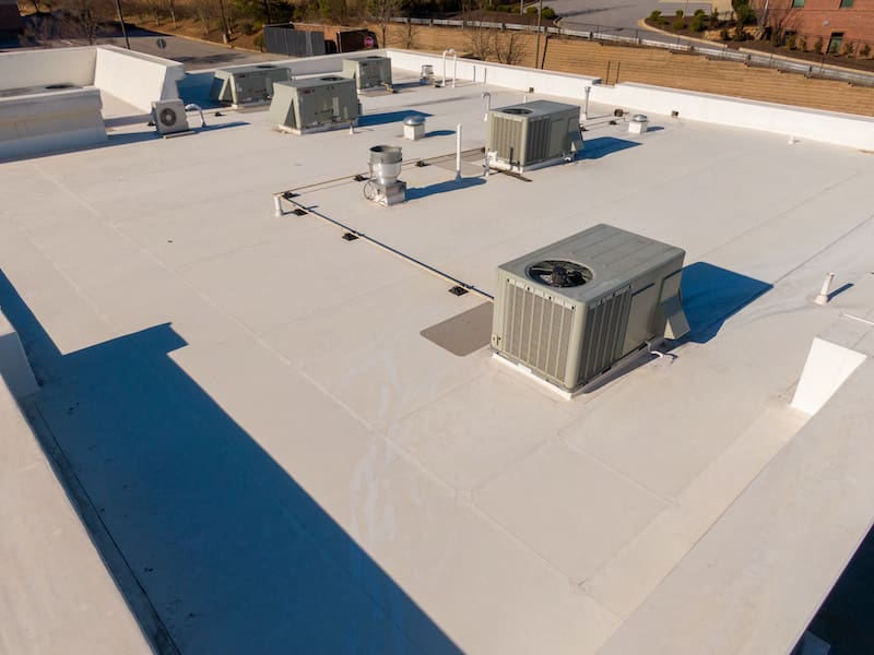 High Resolution Sunny Aerial Drone Image of a New TPO Roof on a Commercial Building With Visible HVAC Equipment Roofing HVAC Architecture Industry - Oak Grove Roofing
